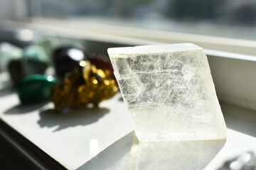 An image of clear Icelandic Spar calcite charging on a white window ledge.