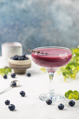 Homemade antioxidant summer blueberry smoothie in a glass on white table