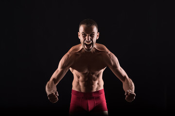 Fototapeta premium Furious shirtless man showing his muscles.