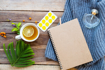 herbal healthy drinks hot honey ,lemon tea and lozenge for health care sore throat with notebook ,perfume and knitting wool scarf of lifestyle woman relax in winter season 