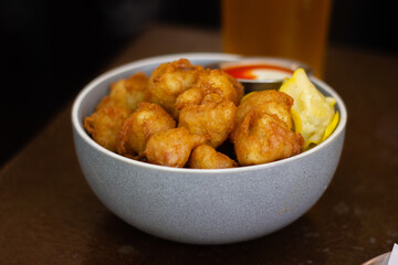 Fried cauliflower bites and hot sauce