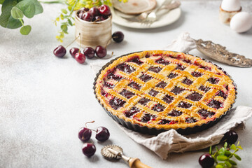 Delicious homemade classic cherry pie with a flaky crust on white background