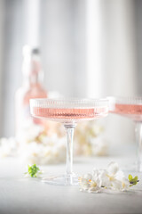 Homemade pink vodka cosmopolitan cocktail drink in crystal glasses