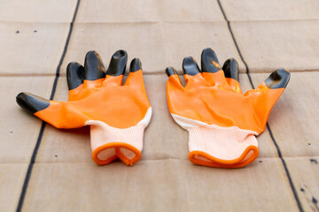 Gloves for construction orange color, protect your hands concept