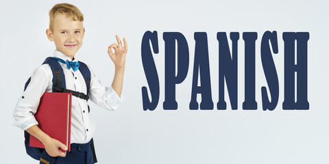 A schoolboy with a briefcase holds books in his hands and shows the gesture ok. The text is written next to it - SPANISH