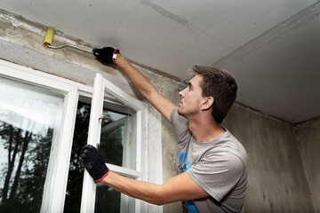 Man works inside of house. © Ludmila Smite