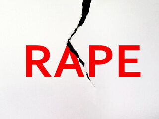 A torn paper with the word RAPE printed in red