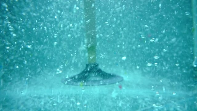 working aerator.liquid and bubbles move inside the glass container.close-up.
