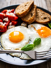 Continental breakfast - sunny side up eggs, toasts and vegetable salad
