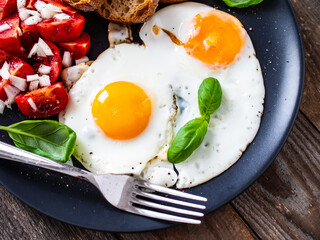Continental breakfast - sunny side up eggs, toasts and vegetable salad
