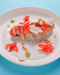 Roll Philadelphia made of fresh salmon and cream cheese inside. Salmon sushi roll with pickled ginger and wasabi sauce.