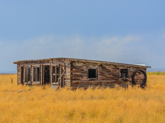 Fototapeta na wymiar A low profile abandoned barn falling apart in rural Colorado