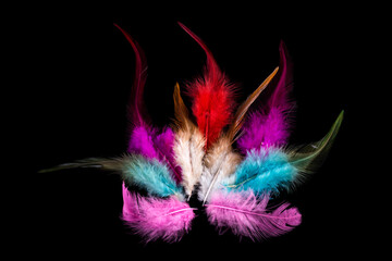 red feathers in the shape of a burning fire on a black background