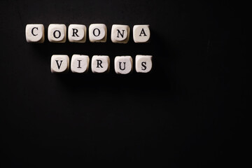Small letters cubes the inscription "virus". On a dark background coronavirus. Director of the virus and coronavirus. World pandemic background.