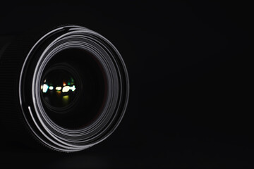 Optics to the camera on the operator’s desk. Flare in the glass of a photo lens. Background with the technique of the photographer.
