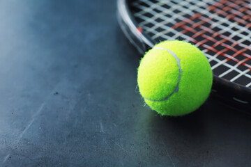 Sport and healthy lifestyle. Tennis. Yellow ball for tennis and a racket on the table. Sports background with tennis concept.