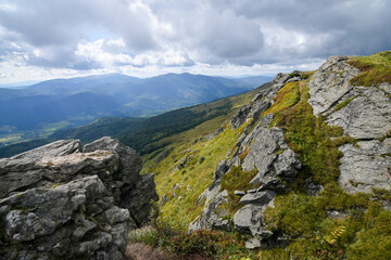 Rocky mountain landscape with blue rainy clouds