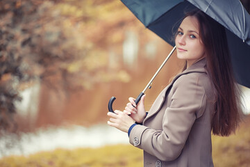 Young girl in a coat in autumn  park