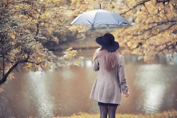 Young girl in a coat in autumn  park