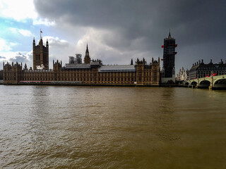 Dark grey sky clouds storm coming or sun comes out winter day in London at westminster abbey bridge...