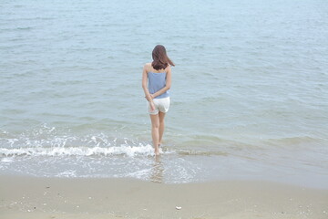 A woman walking into the sea