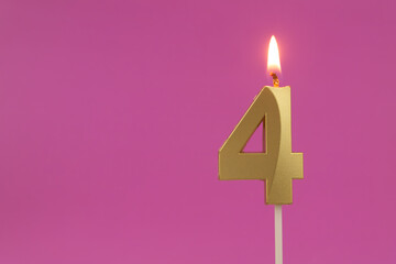 Burning golden birthday candle on pink background with copy space, number 4