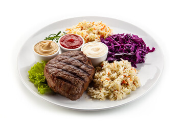 Naklejka na ściany i meble Barbecue beef steak with mix salad, mustard, mayonnaise and ketchup on white background
