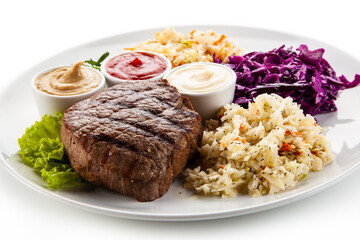Barbecue beef steak with mix salad, mustard,  mayonnaise and ketchup on white background