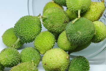 Fresh green colorful spiny gourd or teasel gourd vegetables on white background