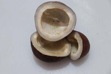 Close up view of dried coconut chips on white background in india