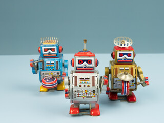 Three robot tin toy on blue background.