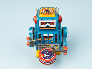 A Robot tin toy on blue background.
