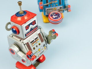 Two Robot tin toy on blue background.