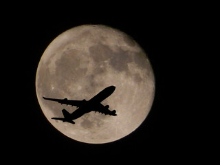 Flight Silhouette over the moon/ Planes flying in front of full moon/ Flight moves across full moon © Tanmay