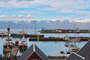 Husavik / Iceland - August 2018: port of Husavik on a clear cloudy day