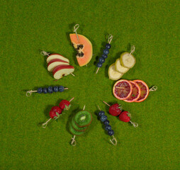 Fruit slices mix on a grass background