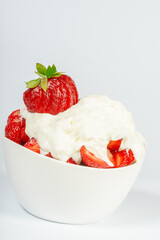 Fresh strawberry with cream in a cup