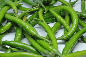 Green cayenne pepper with a white background