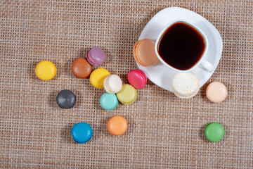 a white cup of coffee and macaroons