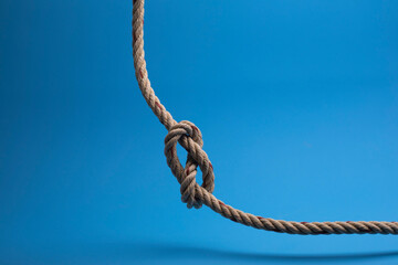 Rope with a knot on blue background