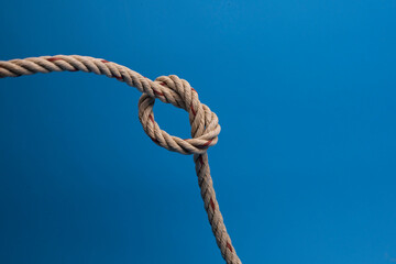 Rope with a knot on blue background