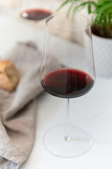 a glass of red wine on a light surface 