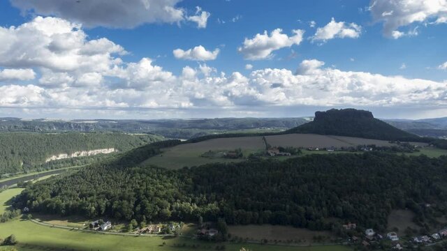 Timelapse - Moving clouds over table mountain Lilienstein as seen from Koenigstein, Saxony, Germany