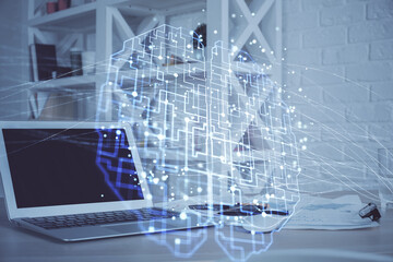 Multi exposure of work table with computer and brain hologram. Brainstorm concept.