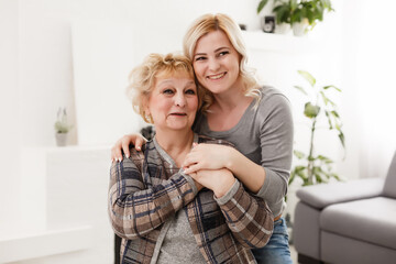 happy senior mother and adult daughter closeup portrait at home