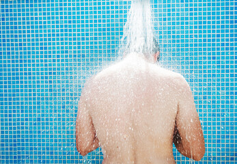 Young man having a shower before pool