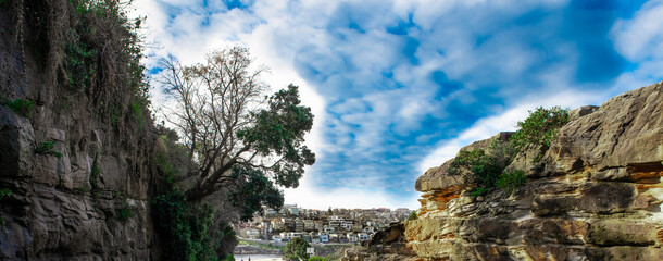 Bronte Beach car park between two rock cliffs with views of the houses on cliff tops Sydney...