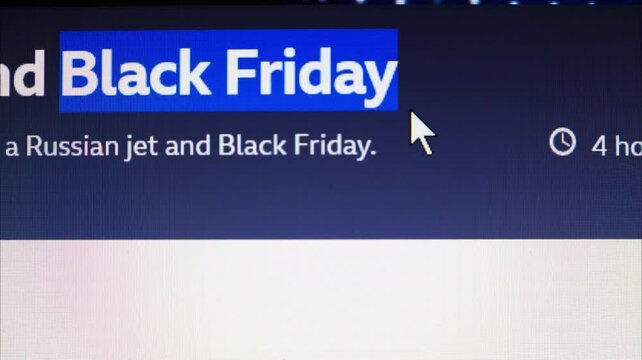 Black Friday is covered in headlines and news sites around the world. Close up view of computer monitor screen. Sales season. Stop movement.