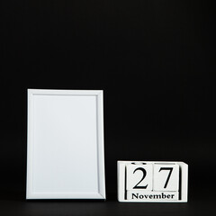 The calendar is November 27, and photo frame mockup on a black background, the concept layout to Black Friday. Copy space.