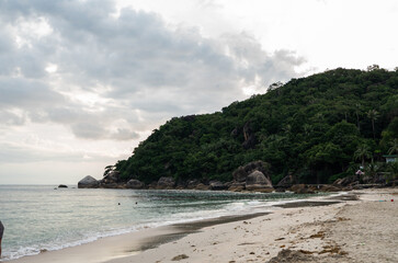 Tropical beach with a crystal blue water with a mountain in Thailand.